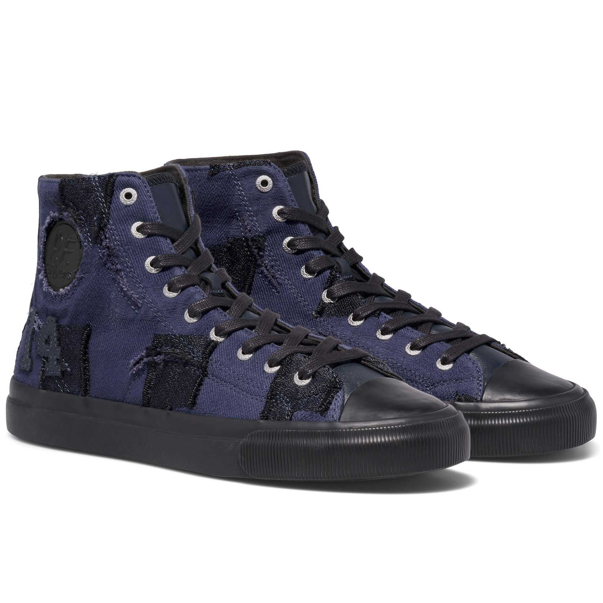Pair of navy high-top sneakers with black soles on a white background