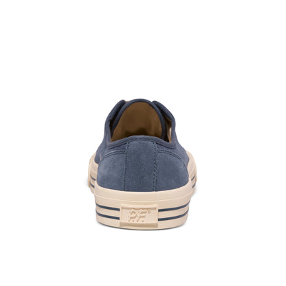 Blue low-top sneaker with beige sole on a white background.