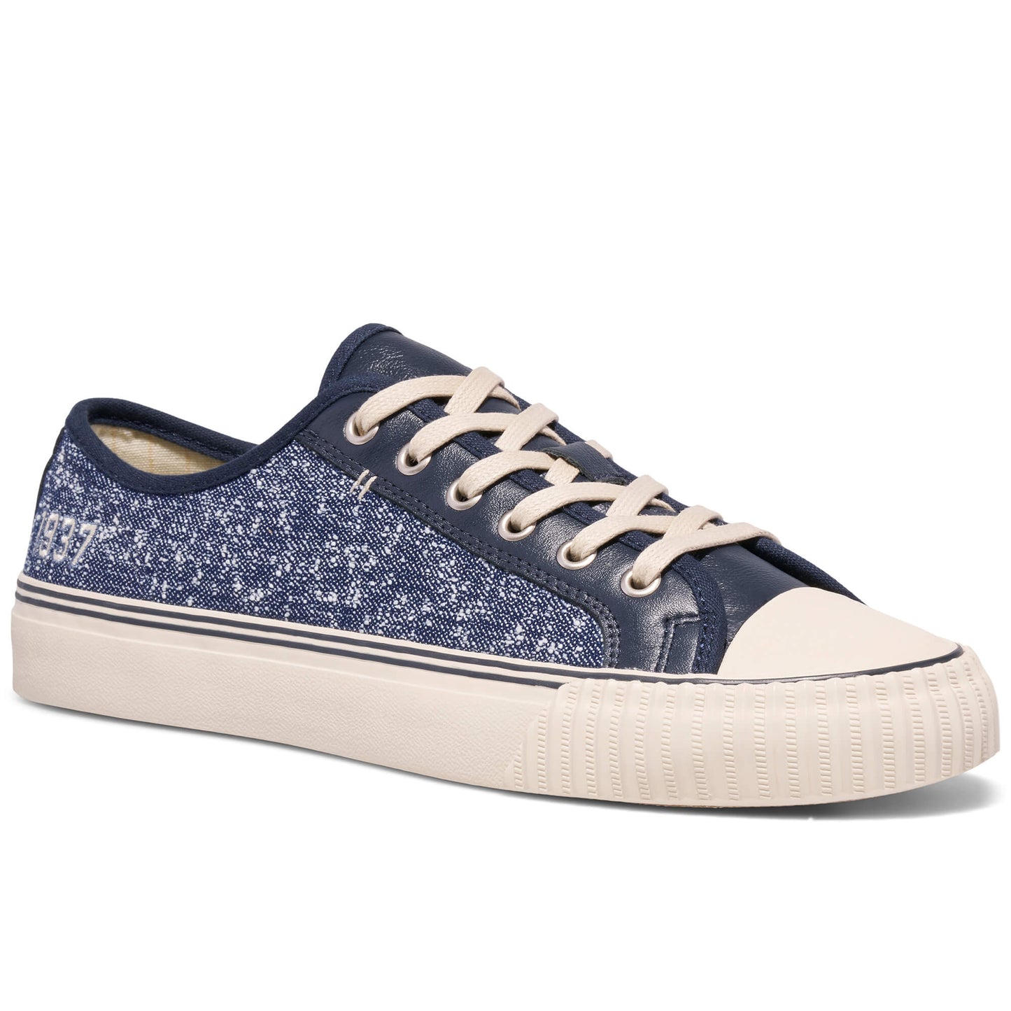Navy blue denim sneaker with white laces on a white background