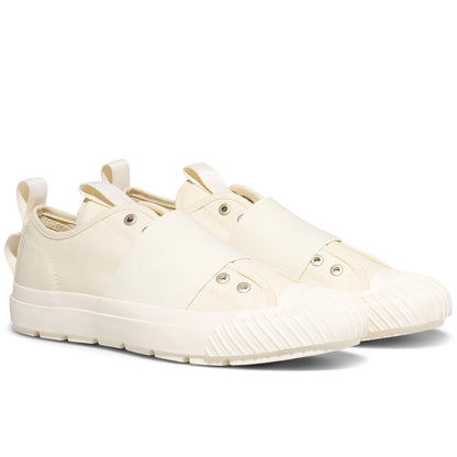 Pair of cream-colored sneakers on a white background