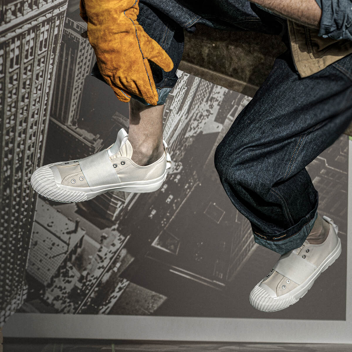 Person wearing white sneakers with a cityscape background